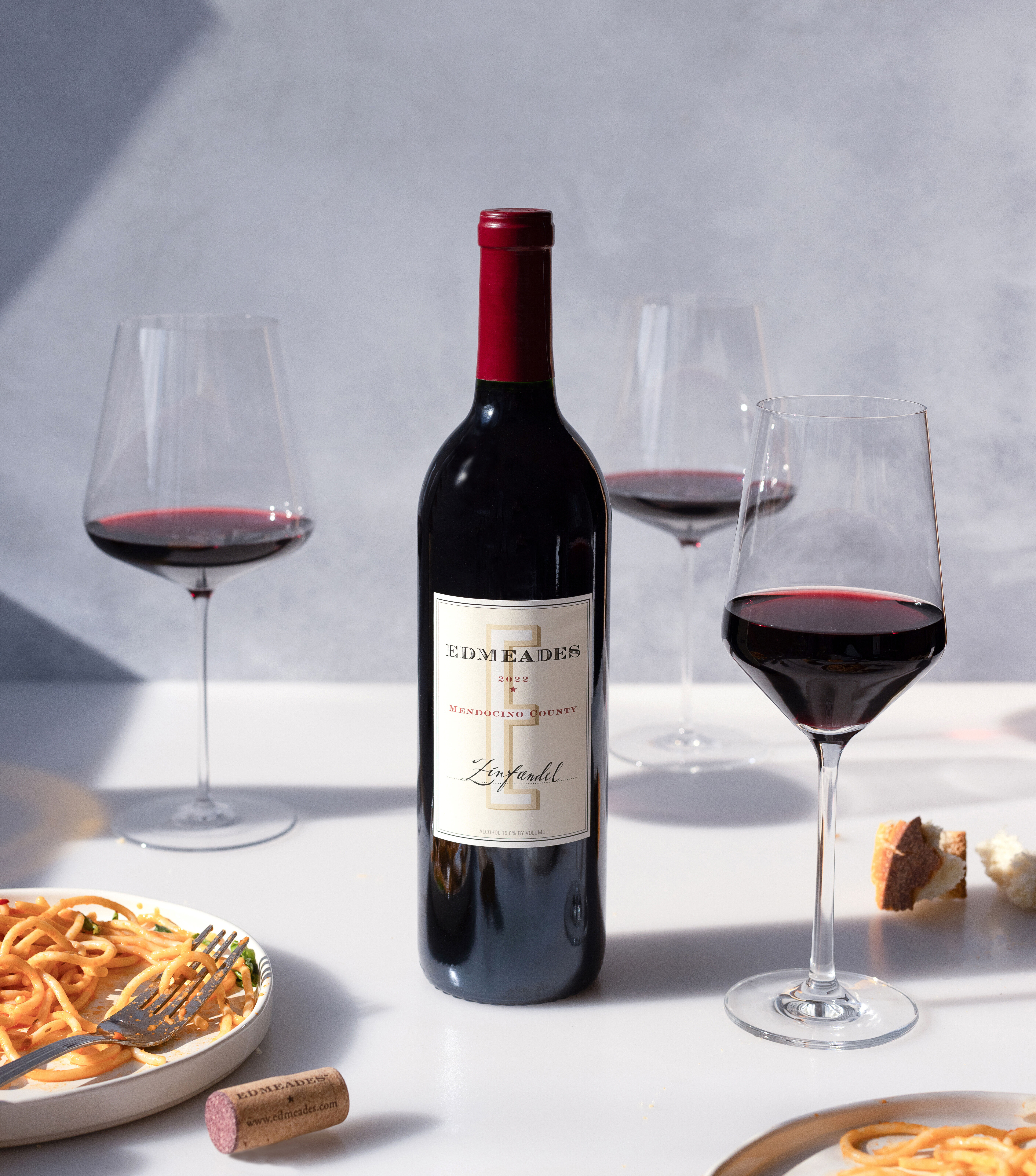 Edmeades Mendocino Zinfandel with glasses of wine and a pasta dish. Copy reads Edmeades Distinctly Mendocino.